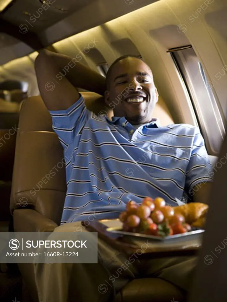 Portrait of a man sitting in an airplane and smiling