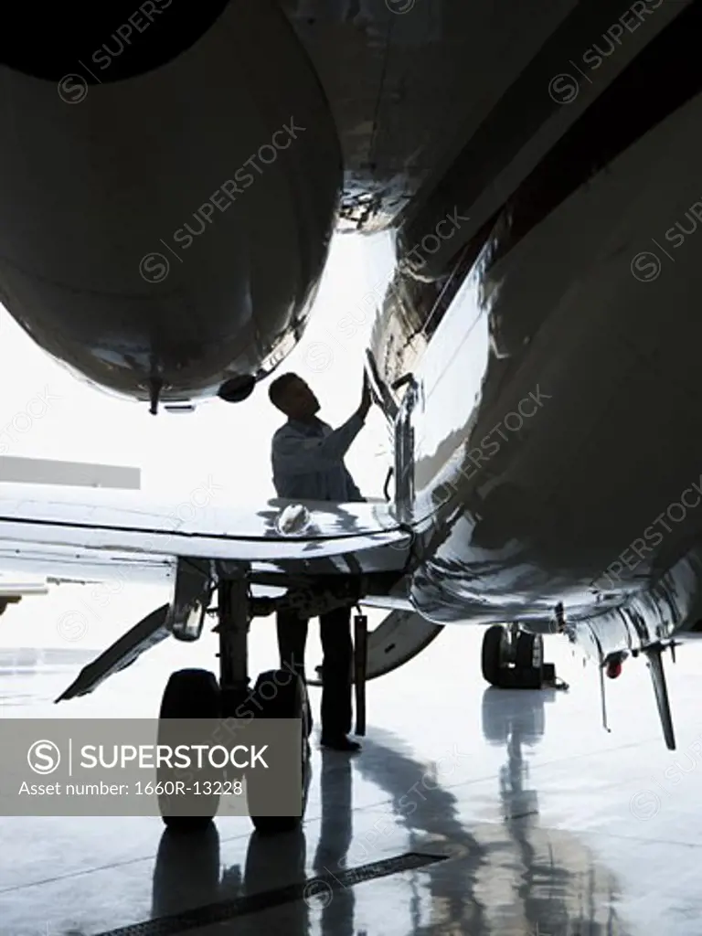A man inspecting an airplane