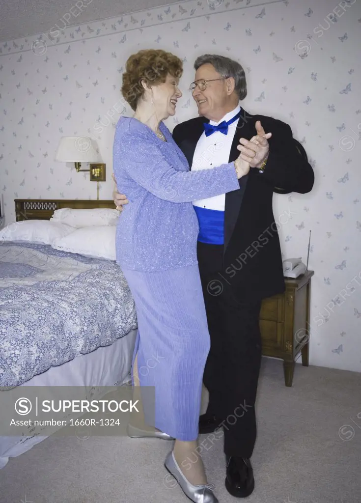 Senior couple dancing in the bedroom