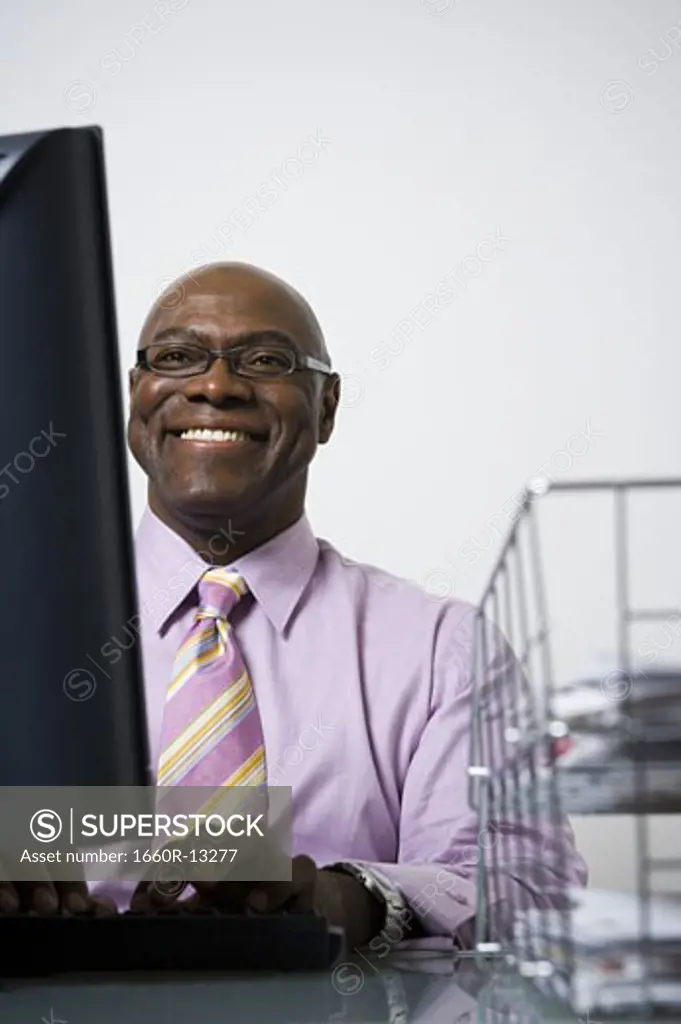 Close-up of a businessman using a computer and smiling