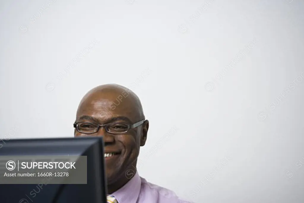 Close-up of a businessman using a computer and smiling