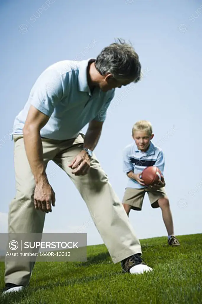 Man playing football with his son