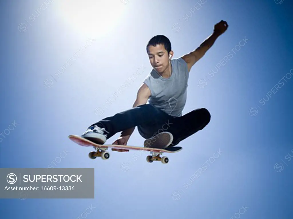 Low angle view of a teenage boy skateboarding