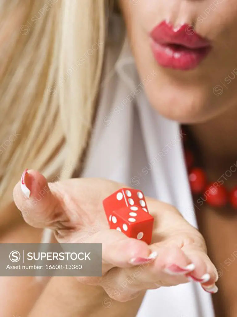 Close-up of a young woman holding a pair of dice