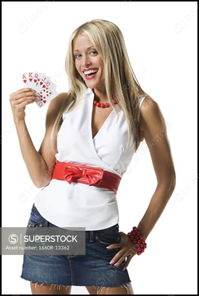 Portrait of a young woman showing playing cards and smiling