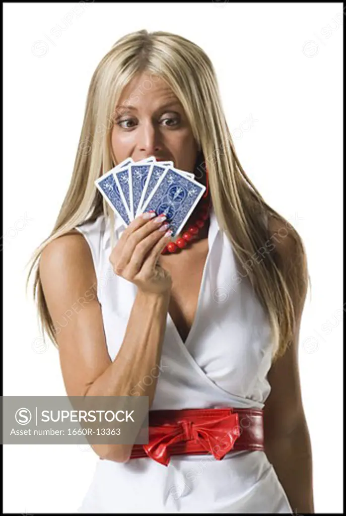 Close-up of a young woman holding playing cards
