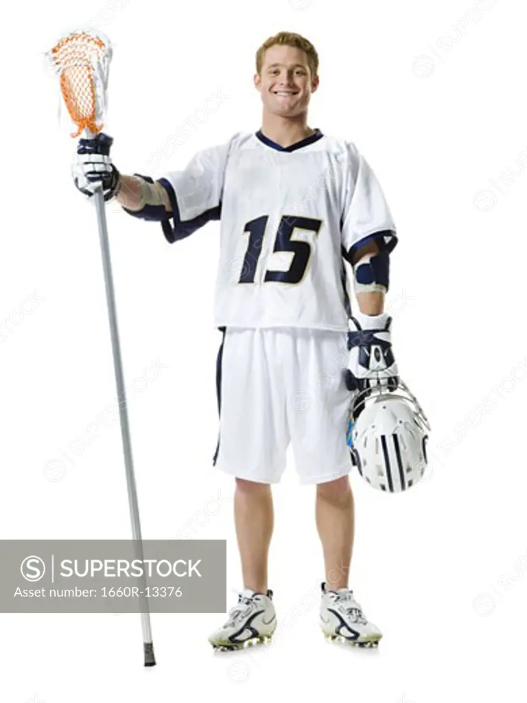 Portrait of a young man holding a lacrosse stick and a helmet