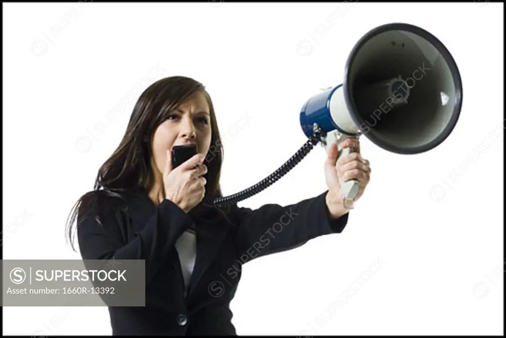 Close-up of a teenage girl shouting into a megaphone