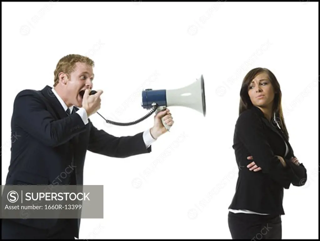 Profile of a businessman shouting into a megaphone with a teenage girl back