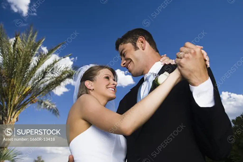 Low angle view of a newlywed couple dancing