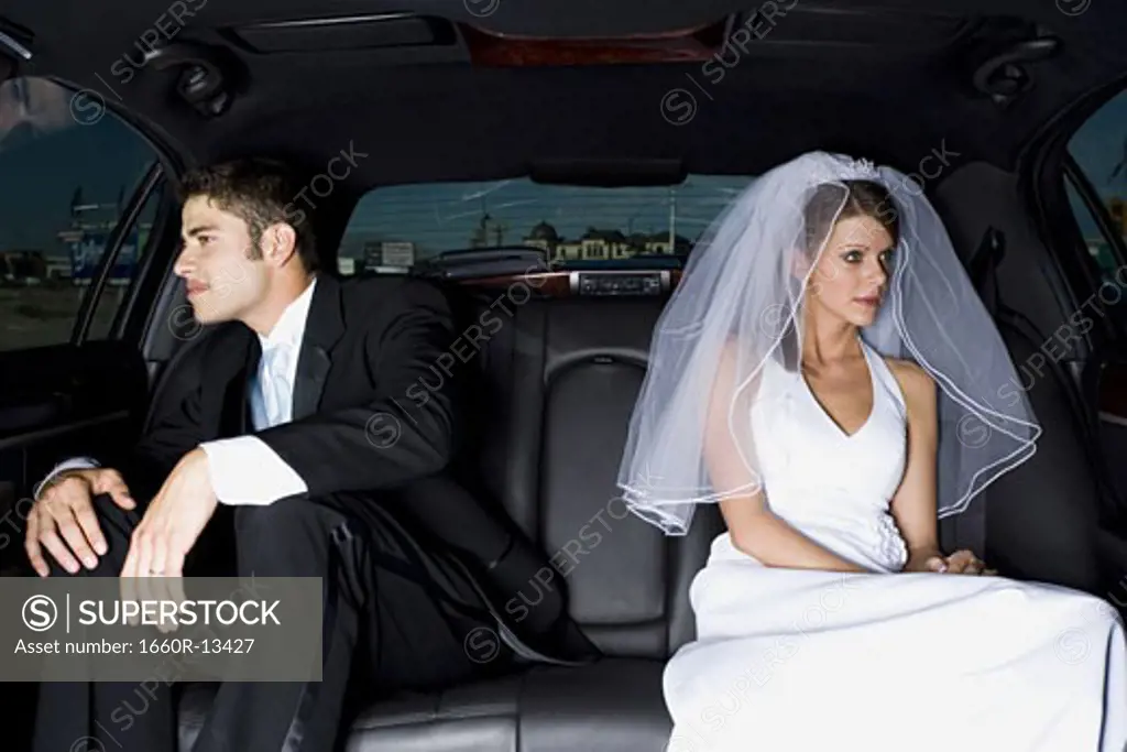 Close-up of a newlywed couple sitting in a car