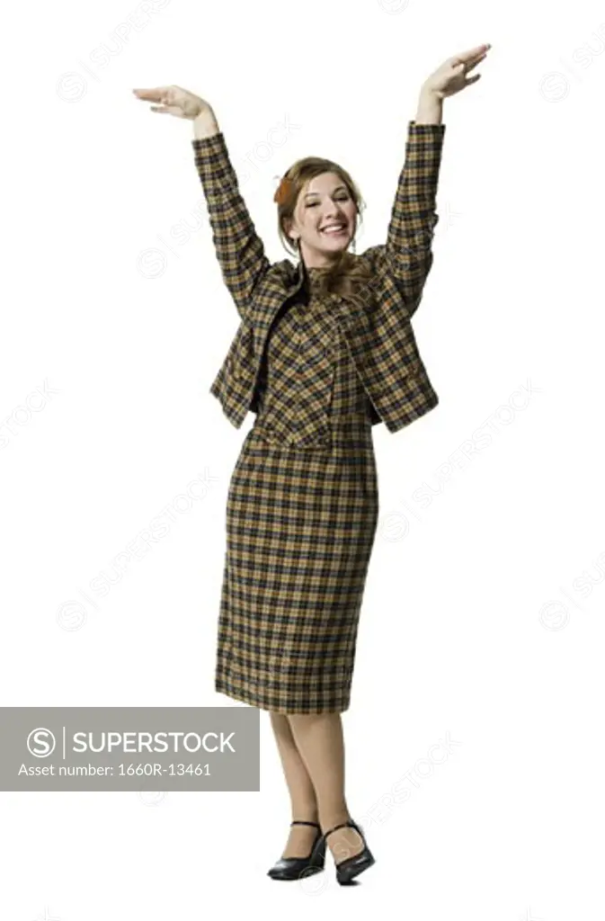 Portrait of a teenage girl posing with her arms raised