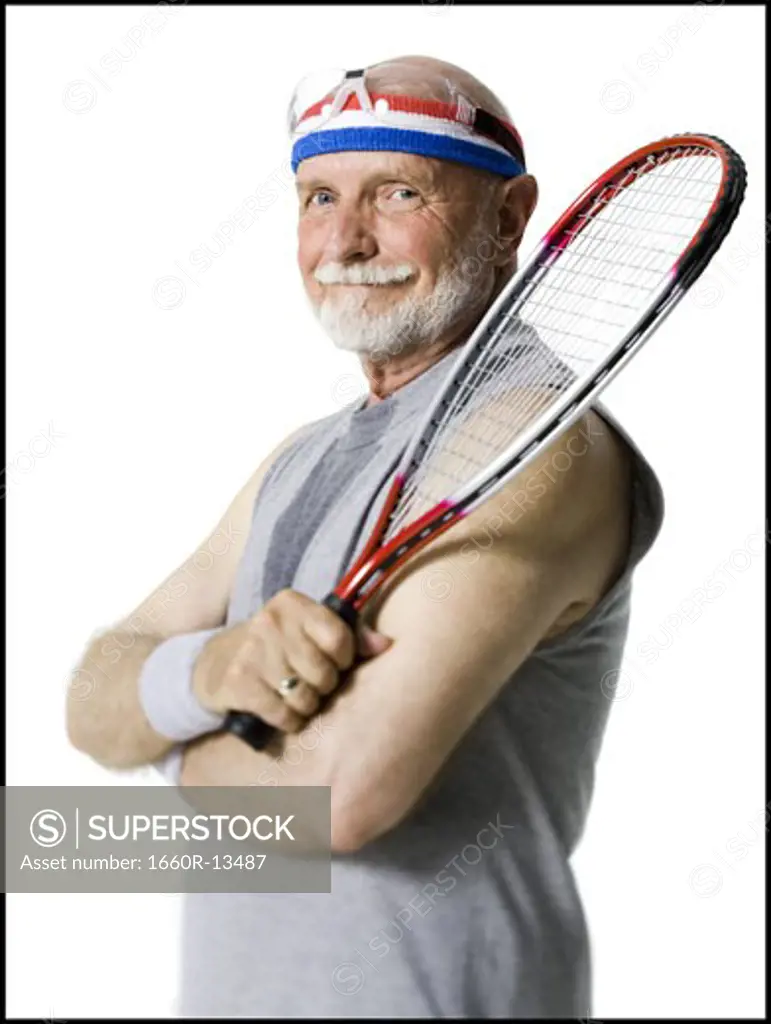 Portrait of a senior man holding a tennis racket