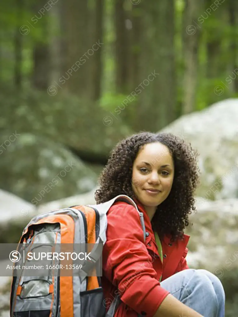 Portrait of a young woman carrying a bag and smiling