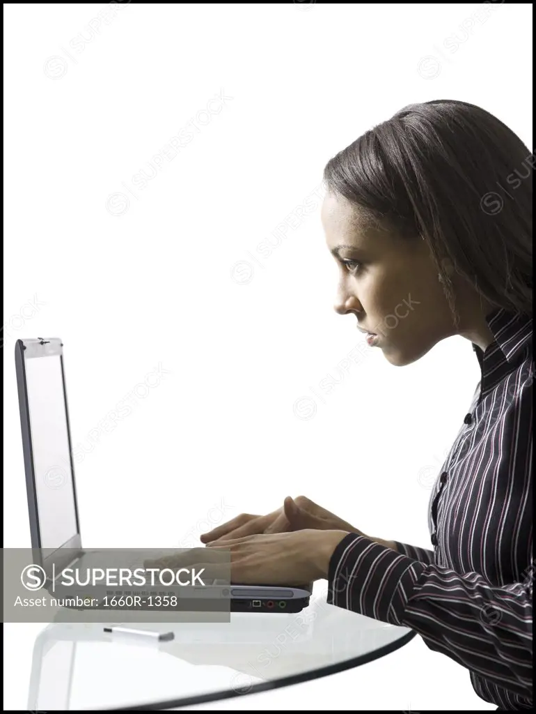 Profile of a young woman using a laptop