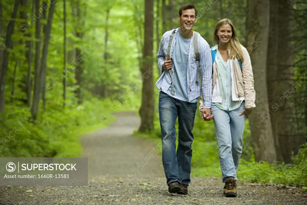 Young couple walking and holding hands