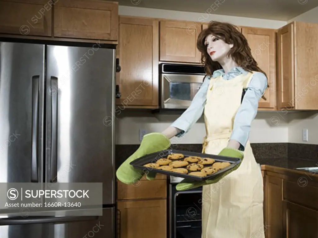 Mannequin portraying a woman holding a tray of biscuits