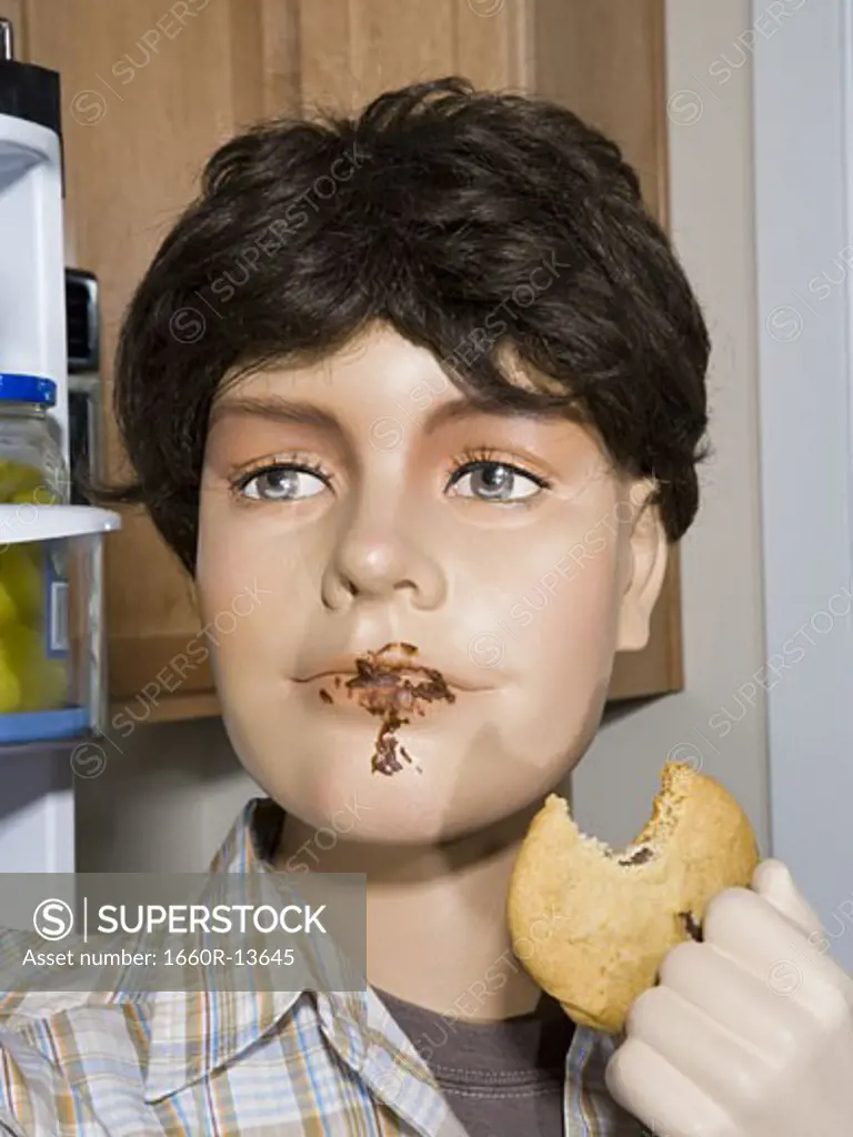 Close-up of a male mannequin holding a cookie