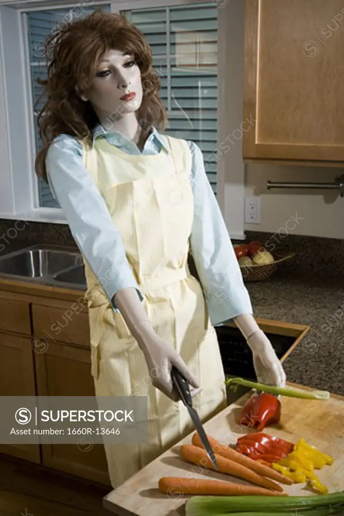 Close-up of a female mannequin holding a knife in the kitchen