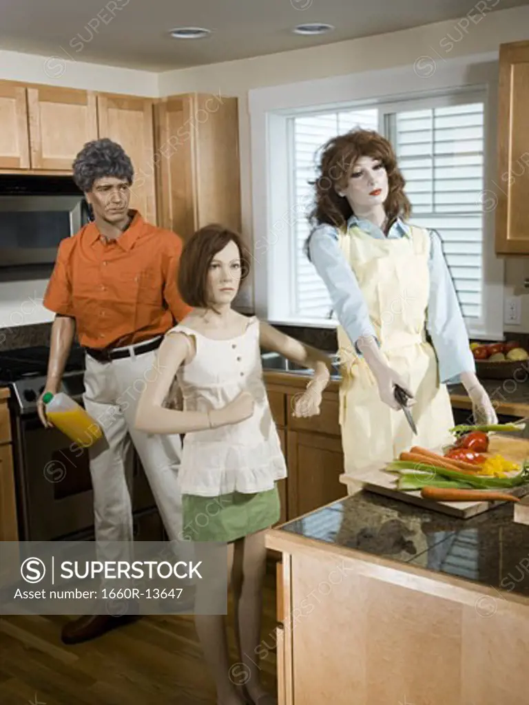 Three mannequins portraying a family in the kitchen