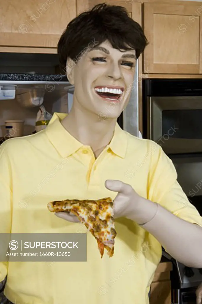 Close-up of a male mannequin holding a piece of pizza and laughing