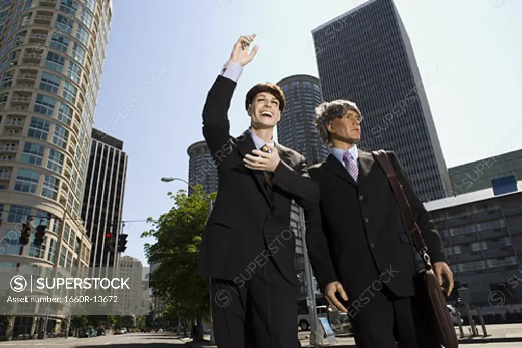 Low angle view of two mannequins portraying businessmen