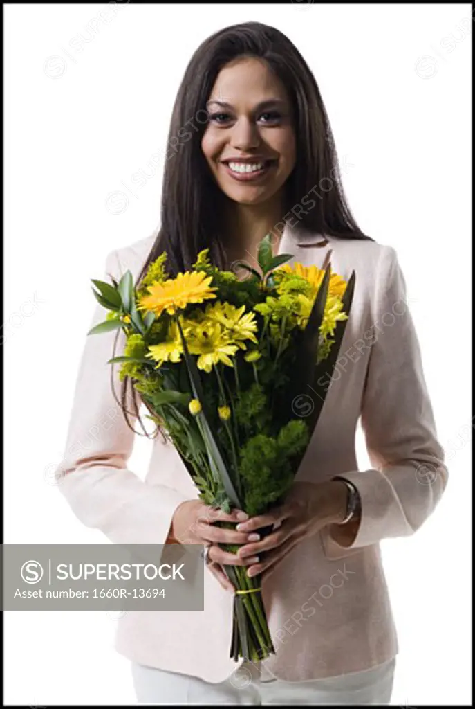 Portrait of a young woman holding a bouquet of flowers and smiling