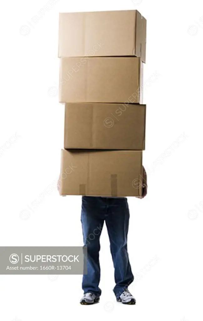 Low section view of a man holding a stack of cardboard boxes