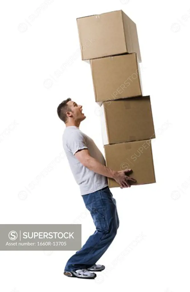 Profile of a young man holding a stack of cardboard boxes