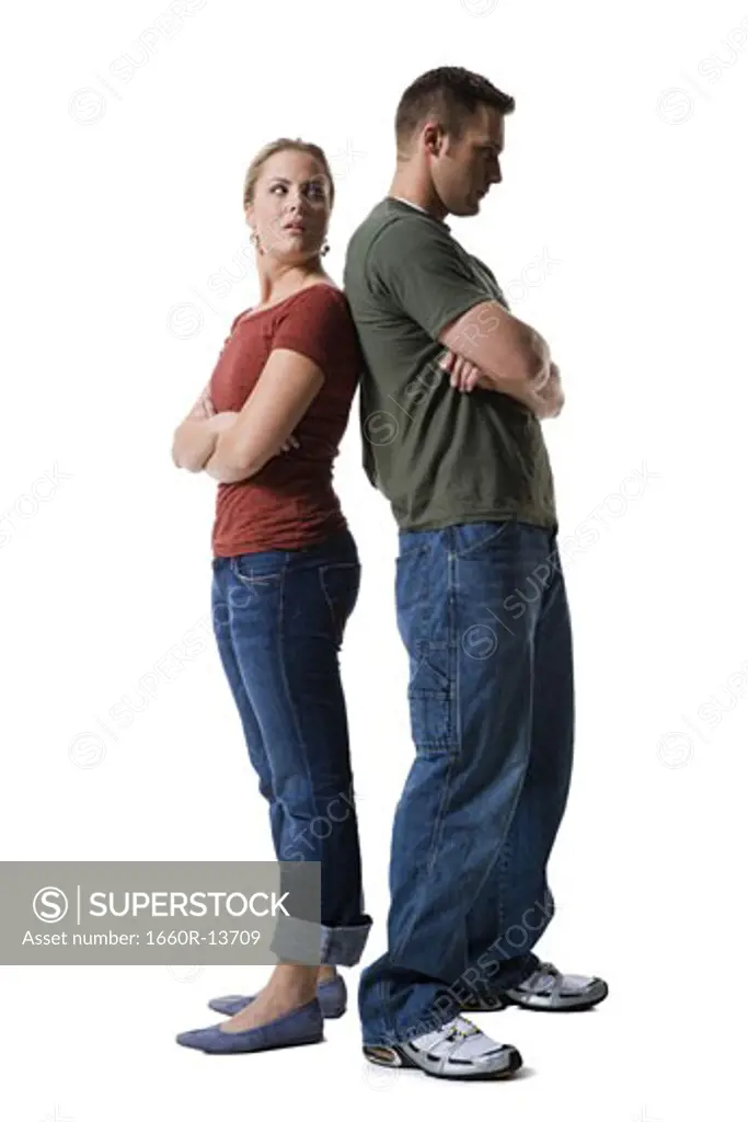 Profile of a young couple standing back to back