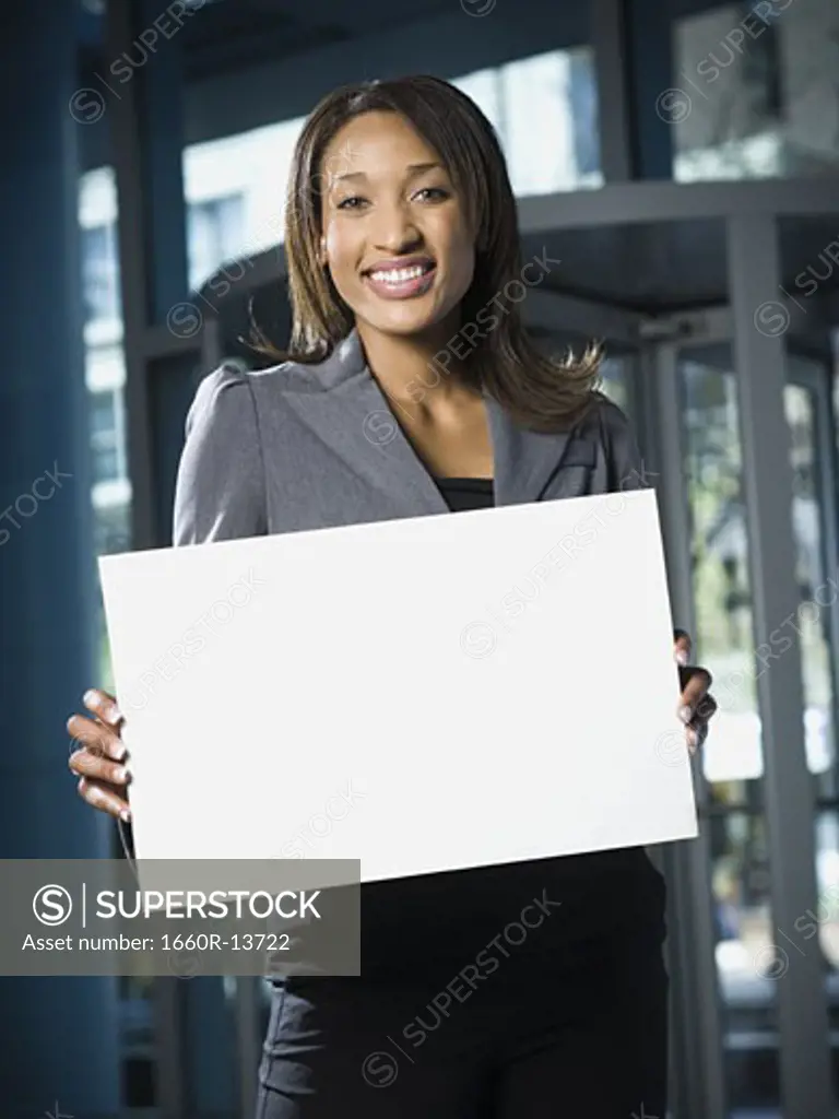Portrait of a businesswoman holding a blank sign