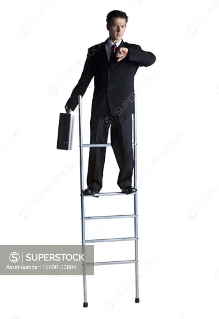 Businessman on corporate ladder checking wristwatch