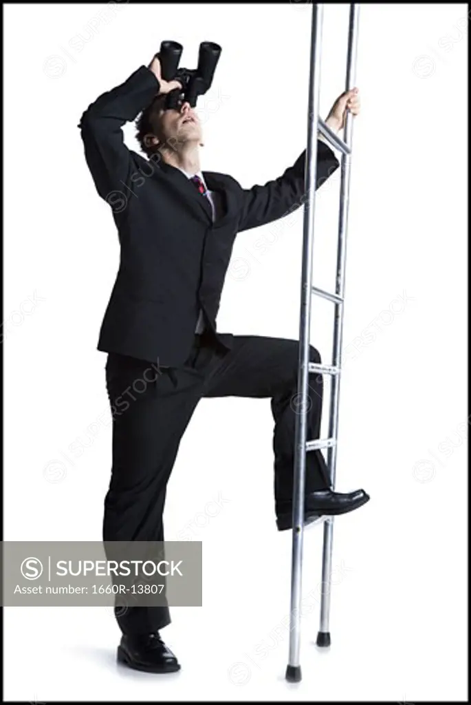 Businessman looking up corporate ladder with binoculars