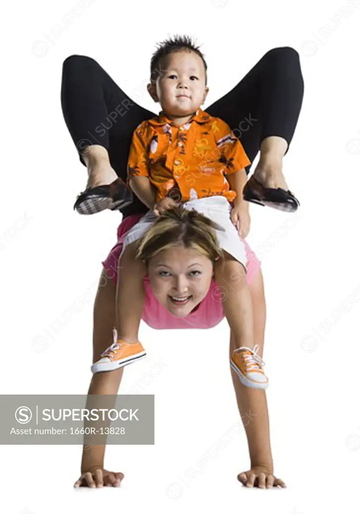 Contortionist mother with young son on back