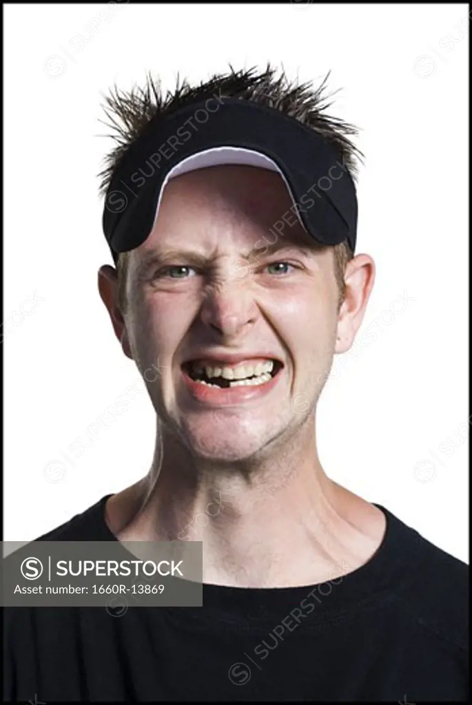 Disheveled man with a visor grinning