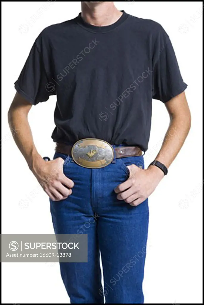 Midsection of slender young man wearing a big belt buckle
