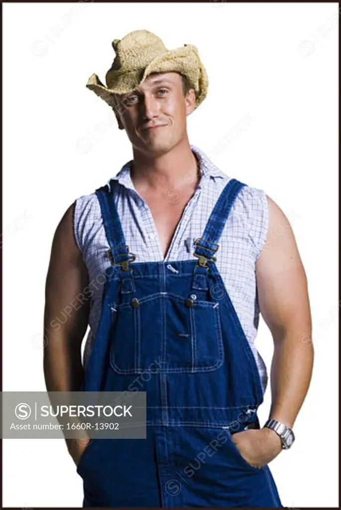 Farmer wearing a straw hat with hands in pockets