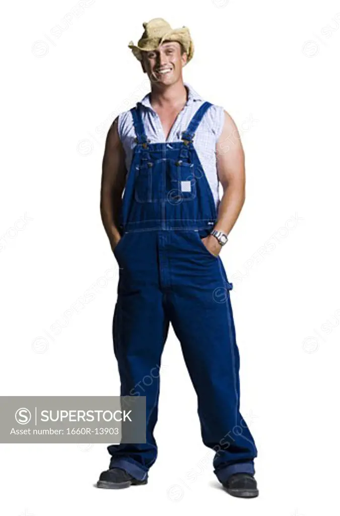 Farmer wearing a straw hat with hands in pockets