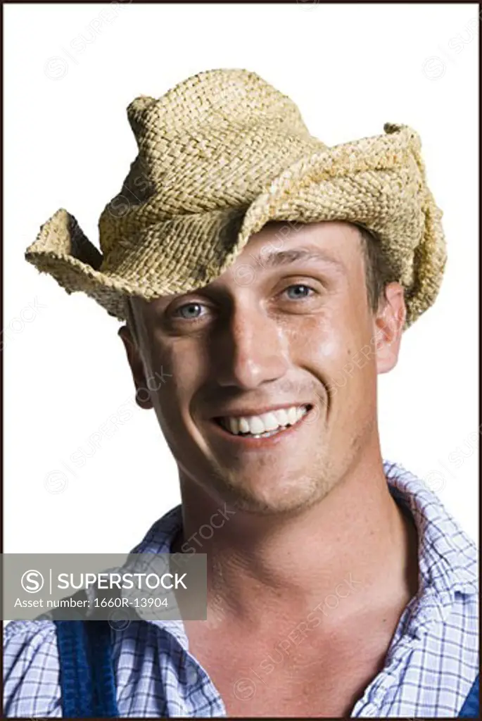 Farmer wearing a straw hat smiling