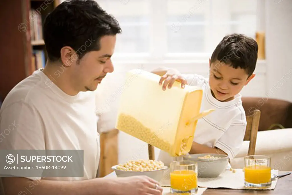 Father and young son having breakfast together