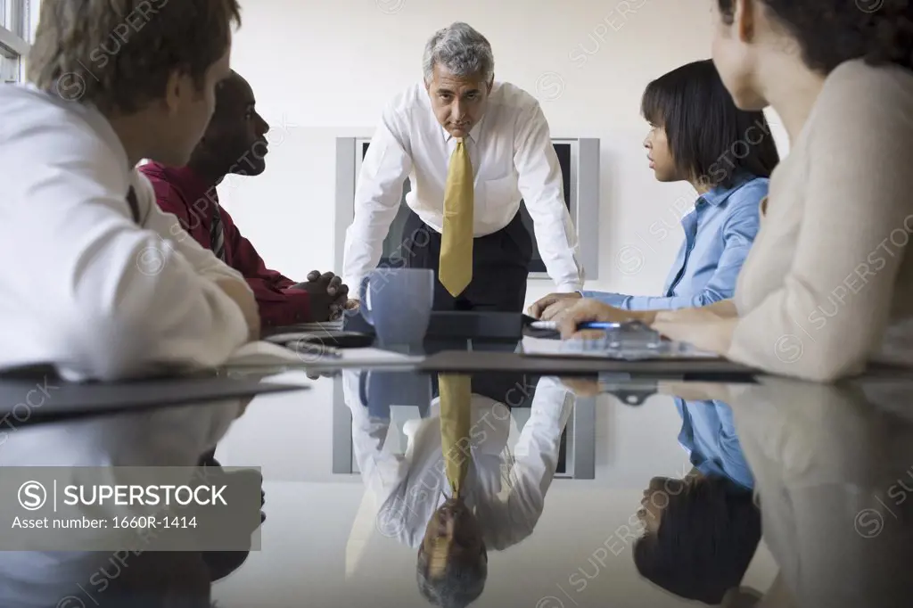 Three businessmen and two businesswomen in a meeting