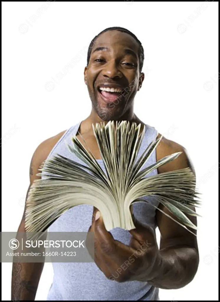 African American holding a pile of dollar bills