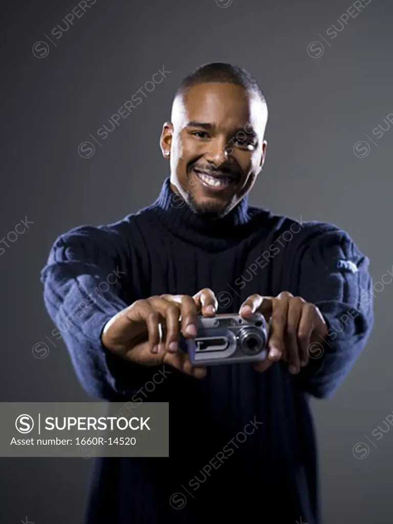 African American taking picture with digital camera
