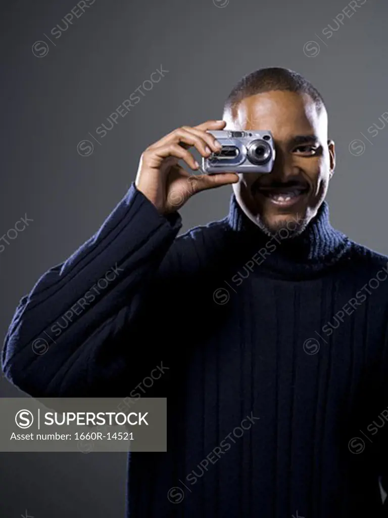 African American taking picture with digital camera