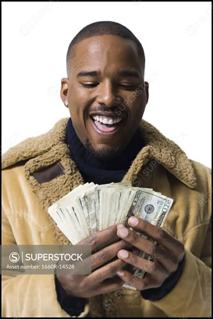 African American holding a pile of dollar bills