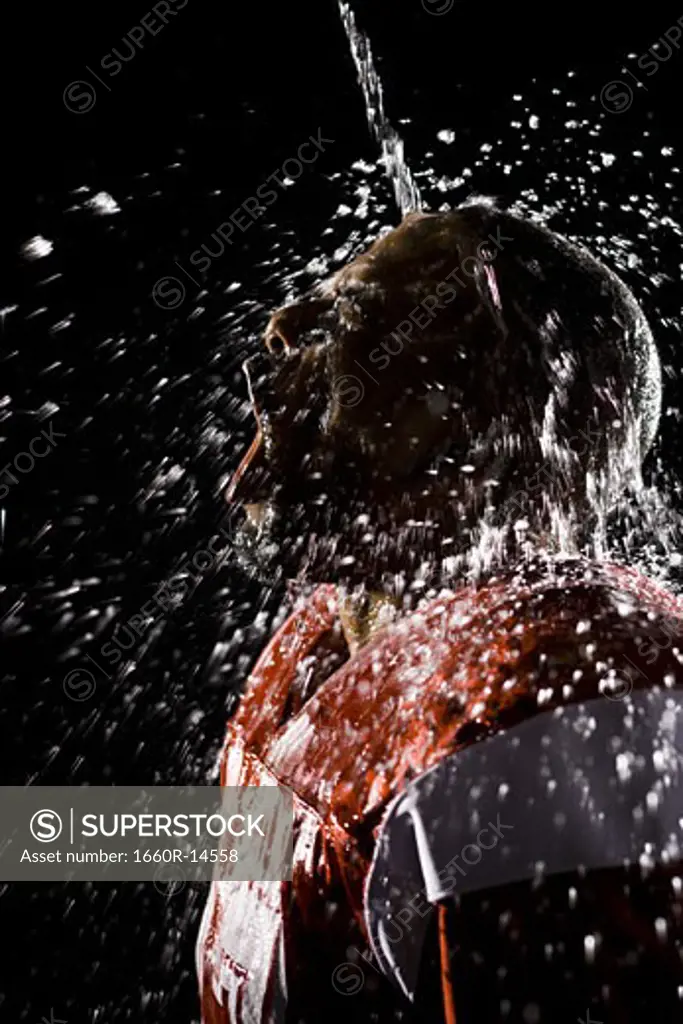 Football player cooling off with water