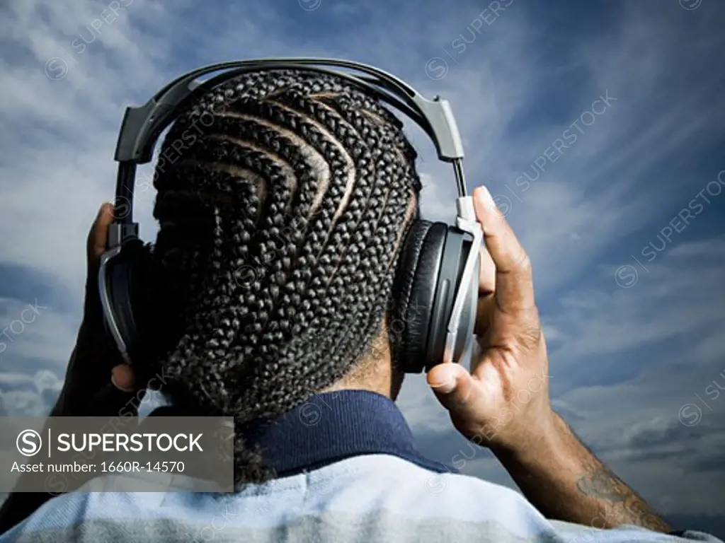 African American man listening to music on headphones