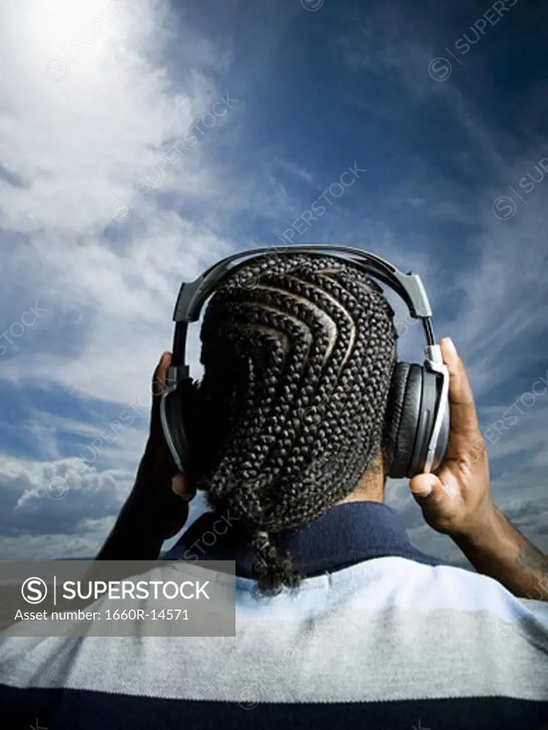 African American man listening to music on headphones
