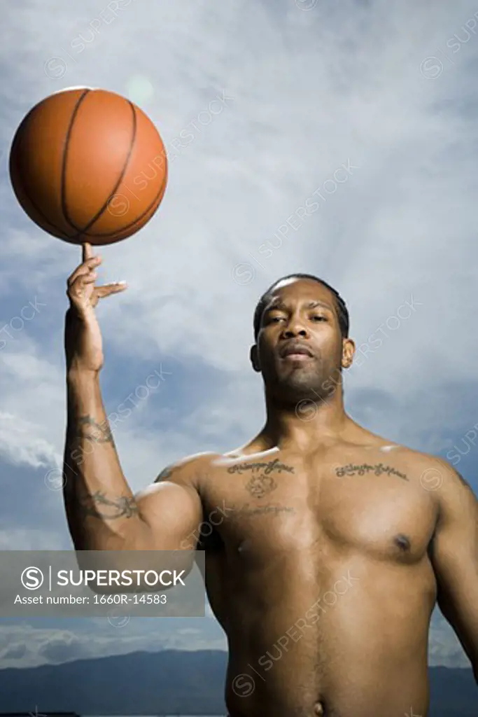 Basketball player spinning ball on finger