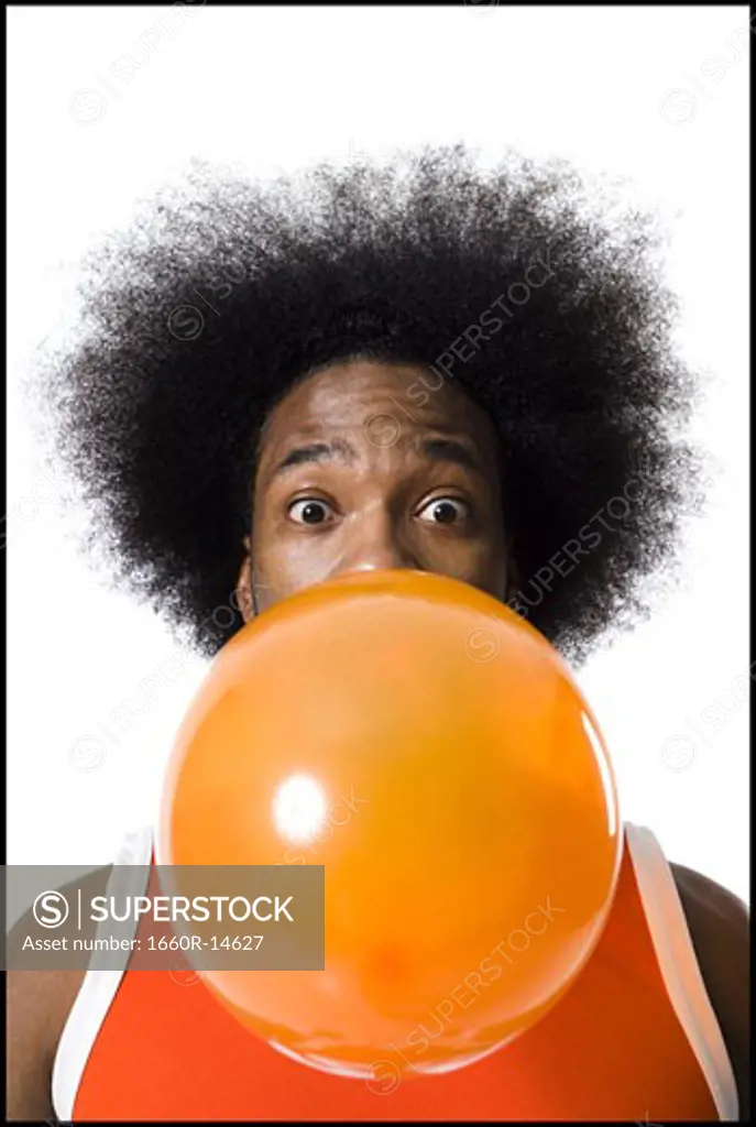 Basketball player with an afro blowing a bubble
